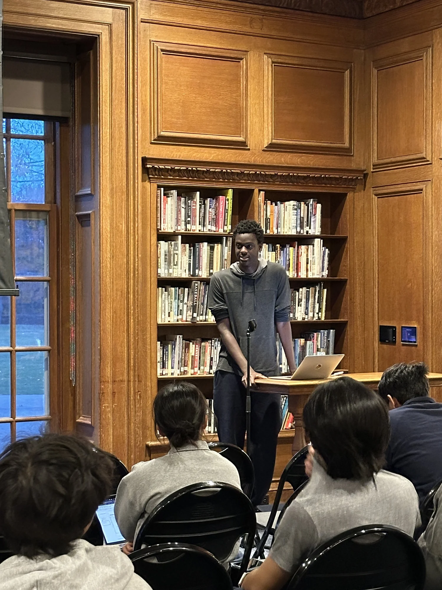A student presenting in a library